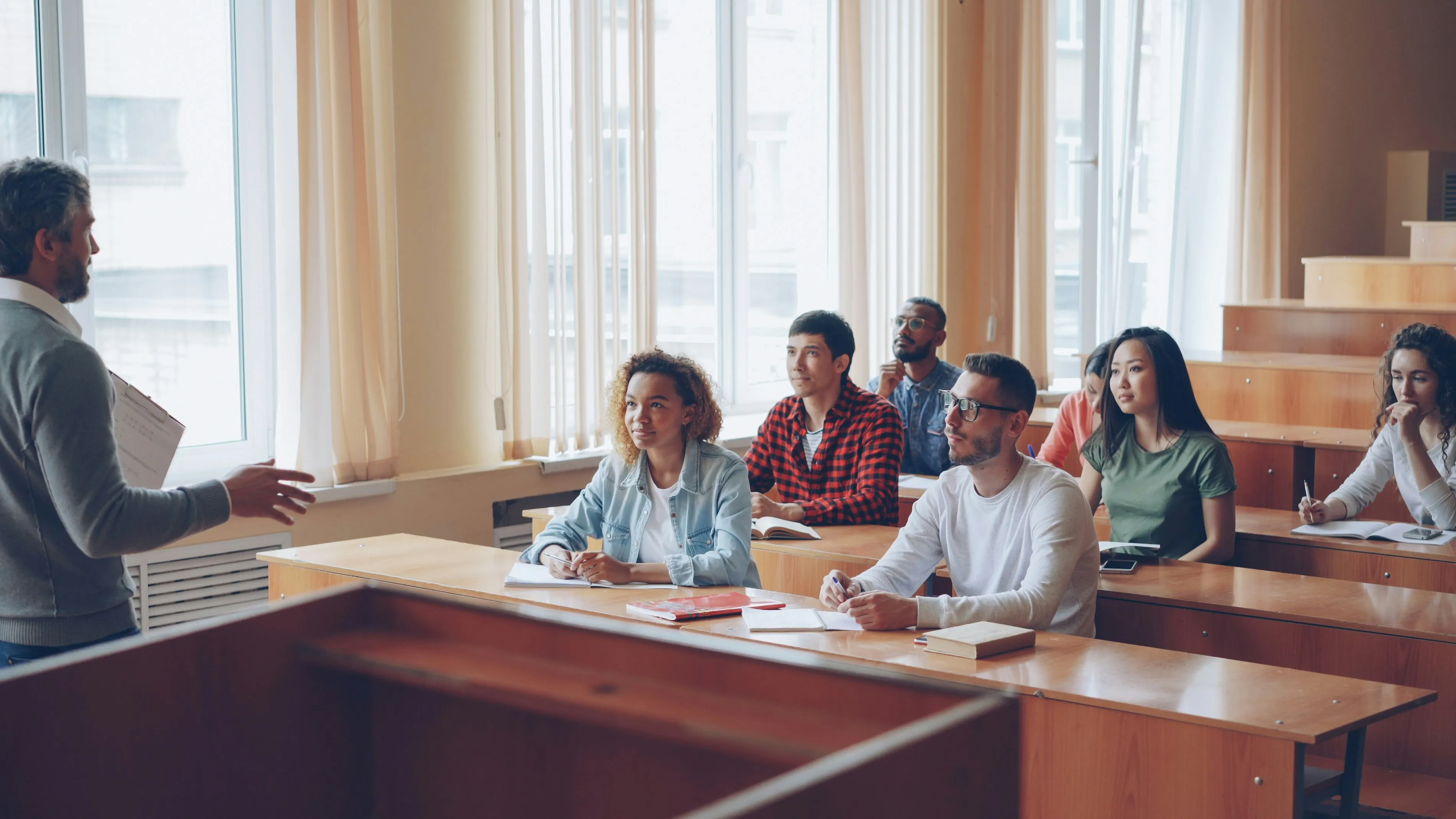 A lecture hall full of students looking remarkably attentive. Statistically, at least two of them are thinking about lunch.
